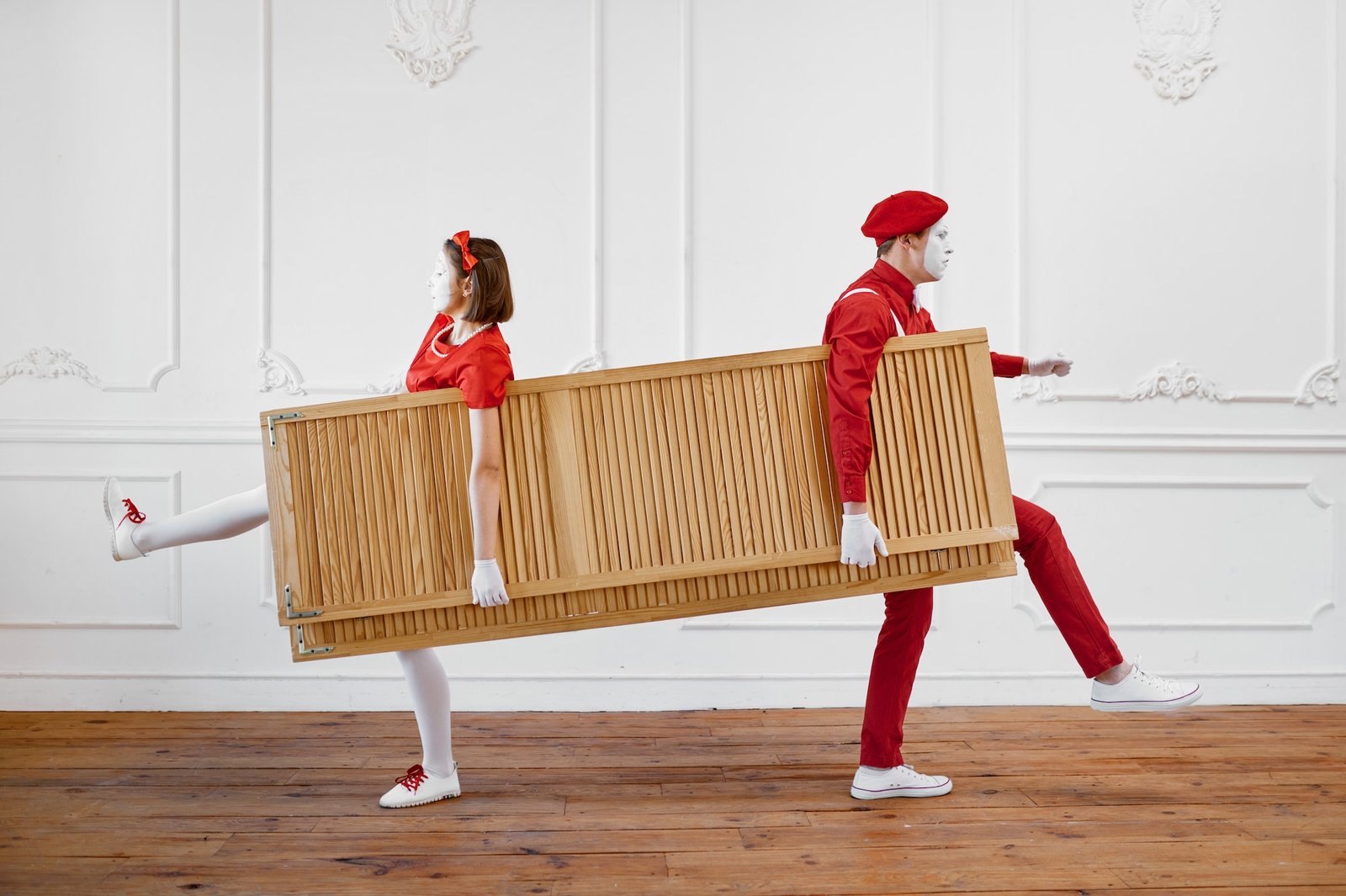 Two mime artists, clowns with wooden partition